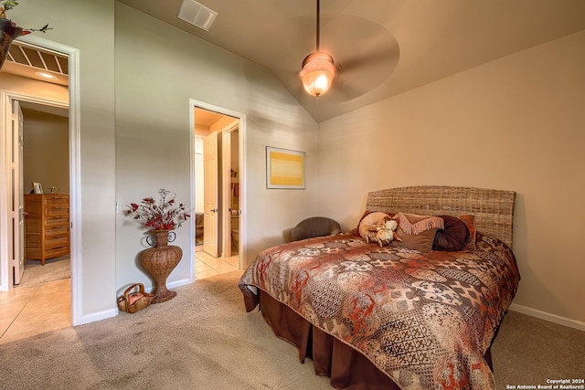 carpeted bedroom featuring ceiling fan, lofted ceiling, and ensuite bathroom