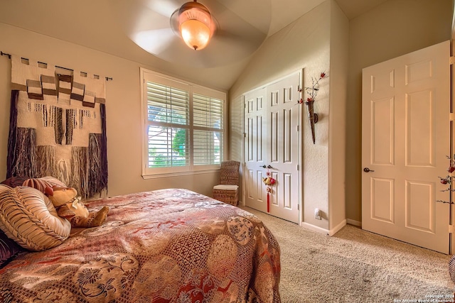 bedroom with vaulted ceiling, ceiling fan, and carpet flooring