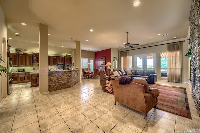 tiled living room with ceiling fan and french doors