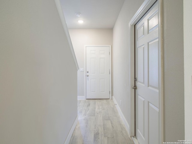 corridor with light hardwood / wood-style flooring