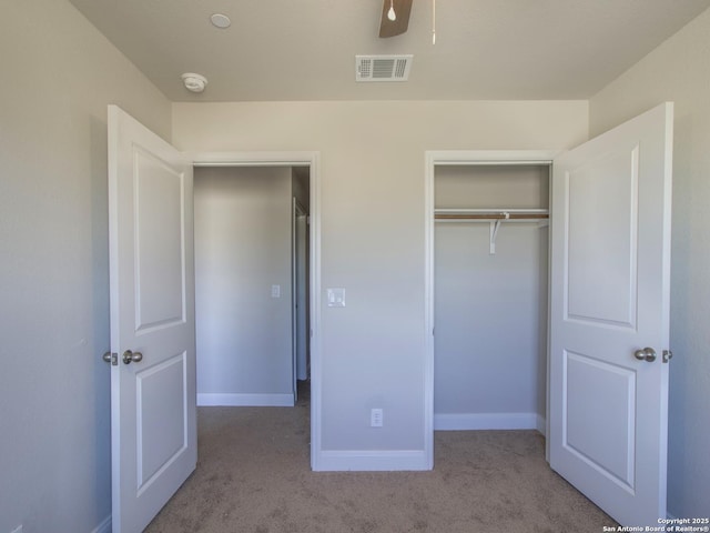 unfurnished bedroom with light carpet, a closet, and ceiling fan