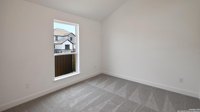 unfurnished room with baseboards and light carpet