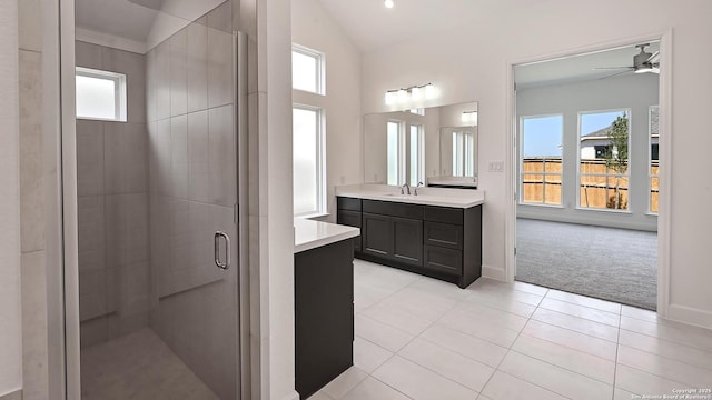 full bathroom with ceiling fan, vanity, tile patterned floors, a shower stall, and lofted ceiling