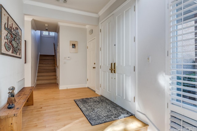 foyer entrance with crown molding and wood-type flooring