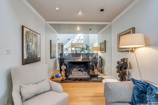 living area featuring wood-type flooring and ornamental molding