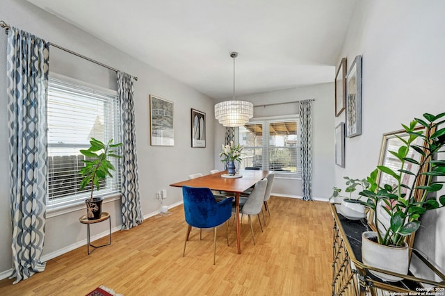 dining area featuring light wood-type flooring and baseboards