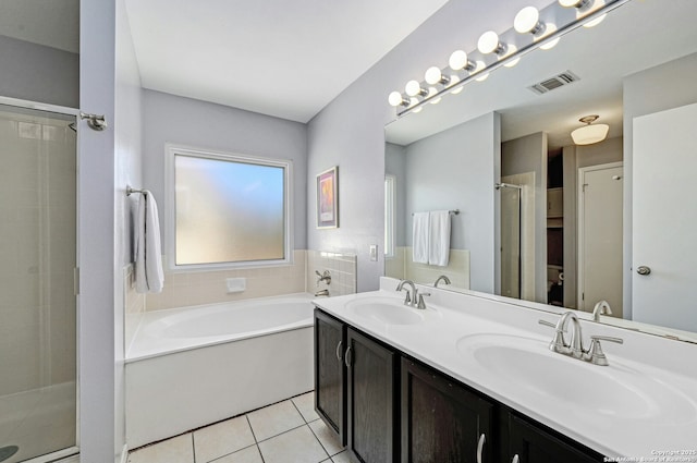 full bathroom with visible vents, a sink, a garden tub, and tile patterned floors