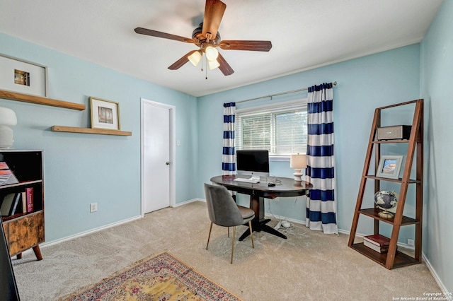 office area with ceiling fan, baseboards, and light colored carpet