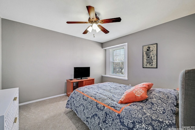 bedroom featuring light carpet, ceiling fan, and baseboards