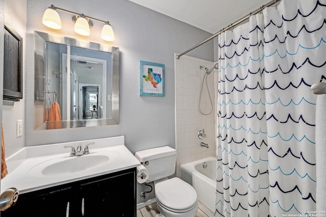 bathroom with toilet, a textured wall, shower / tub combo, and vanity