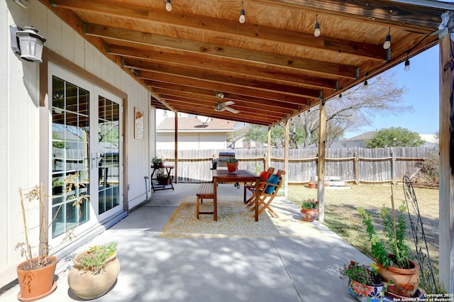 view of patio featuring a fenced backyard, outdoor dining area, and french doors