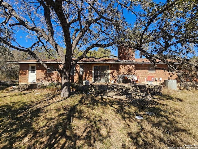 rear view of property with a lawn