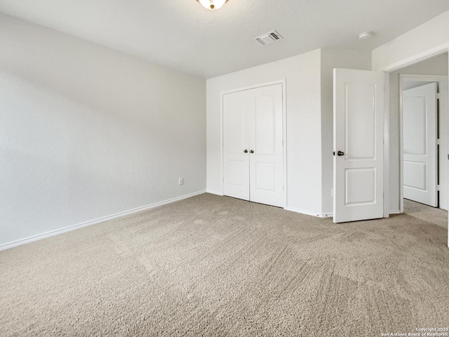 unfurnished bedroom with carpet floors and a closet