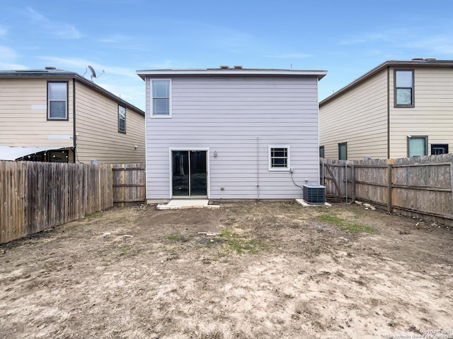 rear view of house with central AC unit