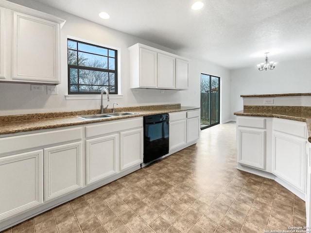 kitchen with white cabinetry, black dishwasher, and sink