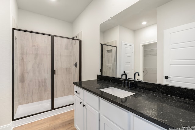 bathroom with vanity, hardwood / wood-style floors, and walk in shower