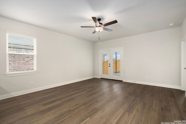 spare room with dark wood-type flooring, ceiling fan, and french doors