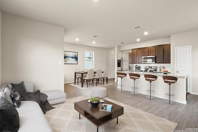 living room with light hardwood / wood-style floors