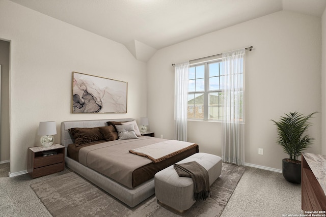 bedroom with vaulted ceiling and carpet