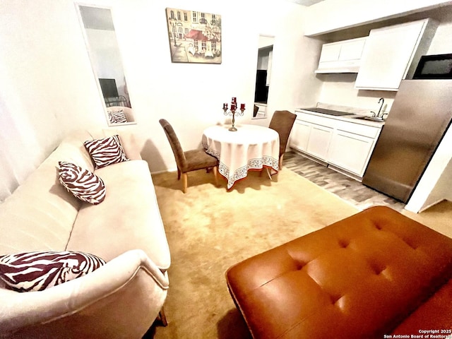 dining area featuring light carpet and sink