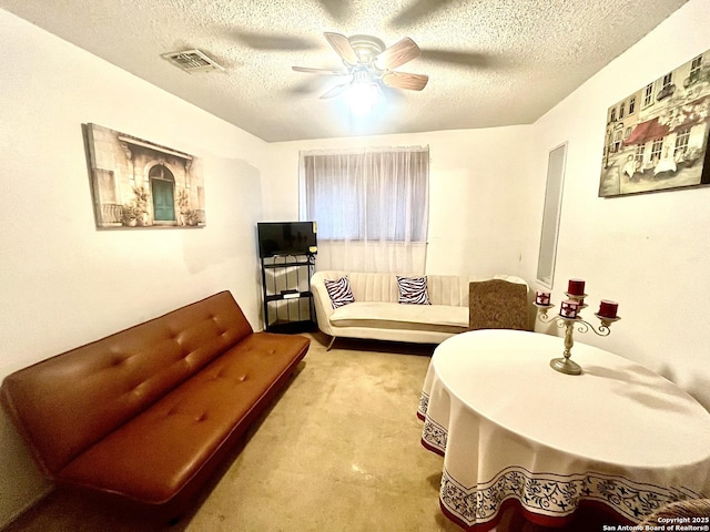 sitting room with ceiling fan and a textured ceiling