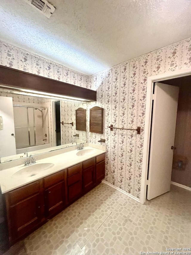 bathroom featuring vanity and a textured ceiling