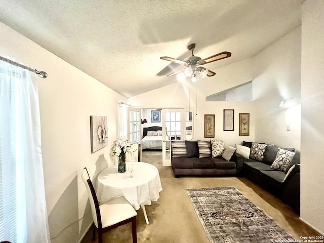 living room with vaulted ceiling, carpet flooring, ceiling fan, and a textured ceiling