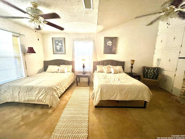 bedroom featuring lofted ceiling, a textured ceiling, and ceiling fan