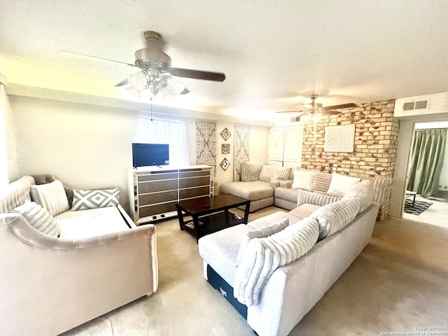 carpeted living room with ceiling fan and a textured ceiling