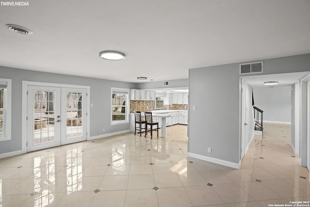 interior space featuring french doors and light tile patterned floors