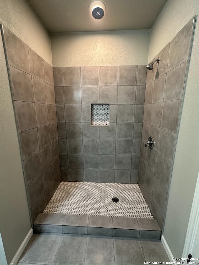 bathroom with a tile shower