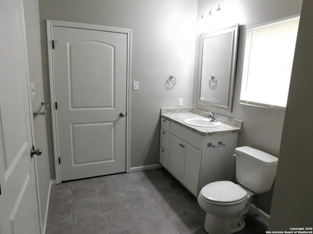 bathroom with tile patterned flooring, vanity, and toilet