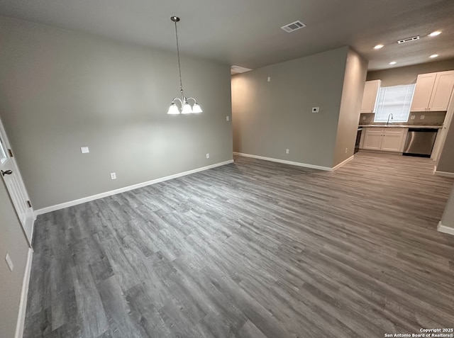 interior space with sink, a notable chandelier, and dark hardwood / wood-style flooring