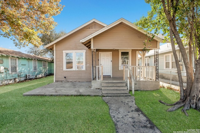 bungalow with a front yard and covered porch