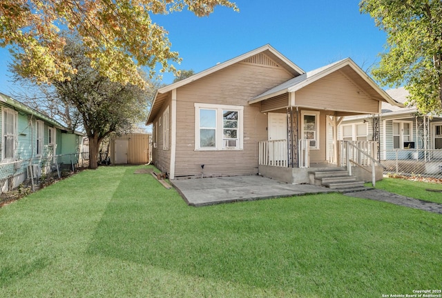 bungalow-style home with a shed, a patio area, and a front yard