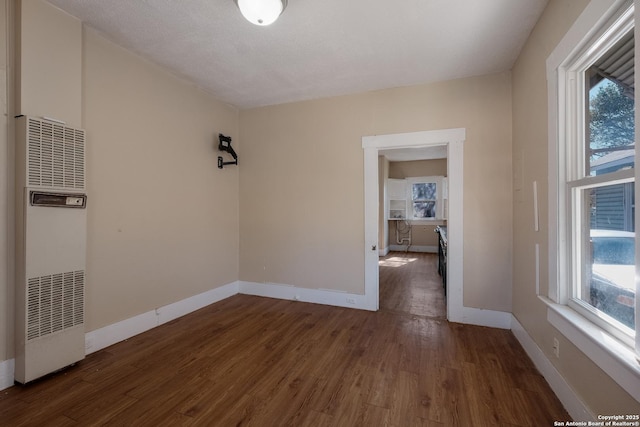 empty room with dark hardwood / wood-style floors