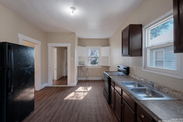 kitchen with sink, dark wood-type flooring, black appliances, dark brown cabinets, and a textured ceiling