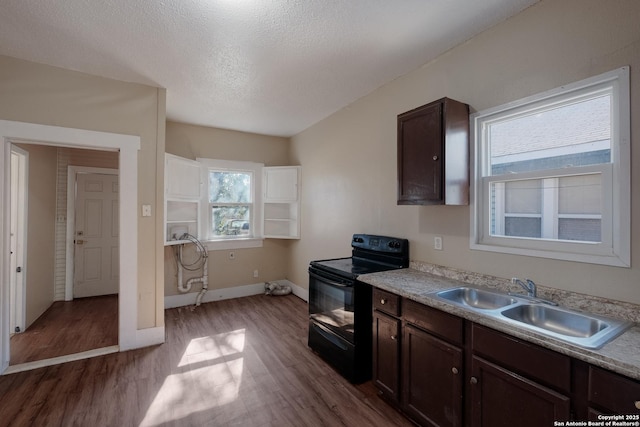 kitchen with sink, hardwood / wood-style flooring, electric range, dark brown cabinets, and a textured ceiling