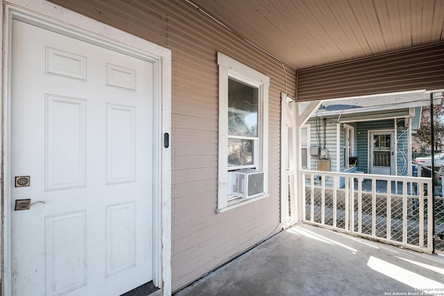 property entrance featuring cooling unit and covered porch