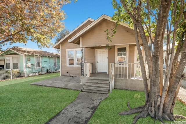 bungalow-style house with a porch and a front lawn