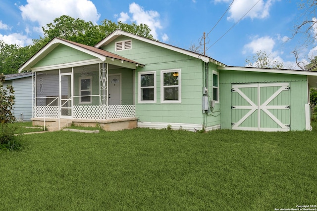 view of front of home featuring a front yard and a sunroom