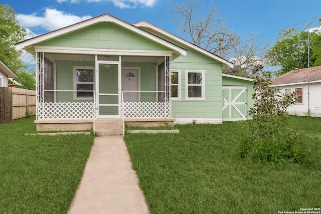 bungalow-style house featuring a front lawn and a sunroom