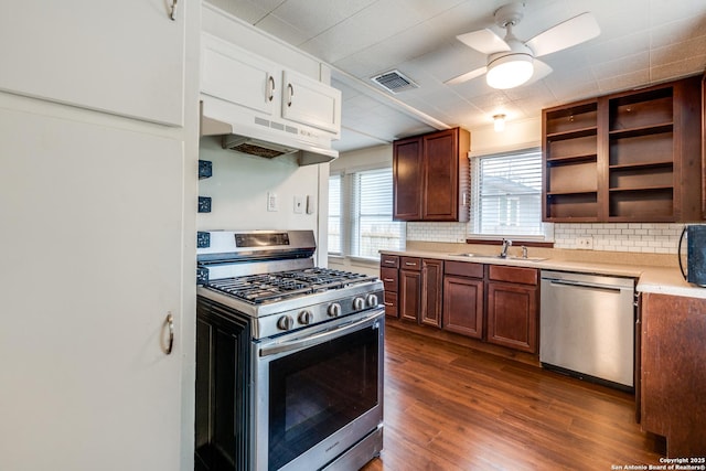 kitchen featuring dark wood-type flooring, sink, tasteful backsplash, ceiling fan, and stainless steel appliances