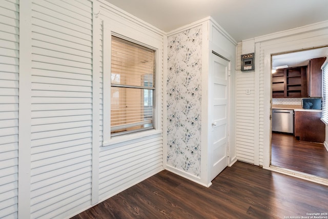 hallway with ornamental molding and dark hardwood / wood-style flooring