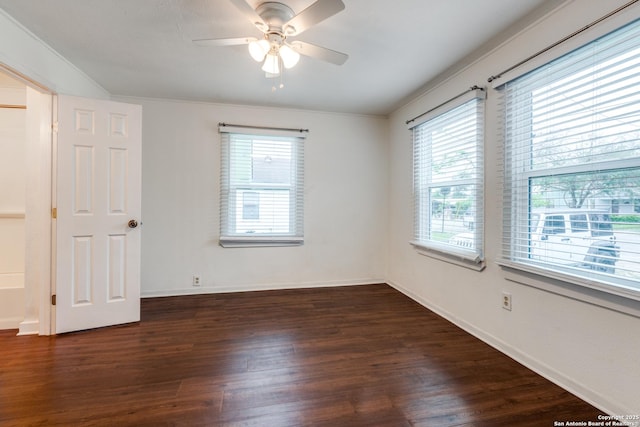 empty room with ceiling fan and dark hardwood / wood-style floors