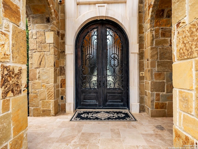 view of exterior entry featuring french doors