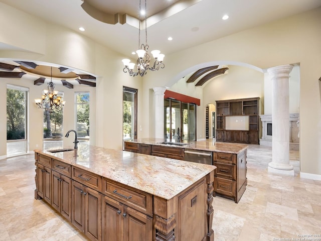 kitchen with a spacious island, sink, and hanging light fixtures