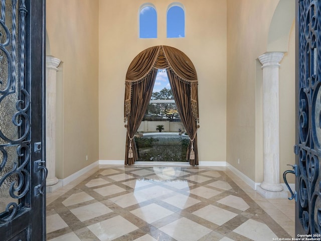 foyer featuring decorative columns