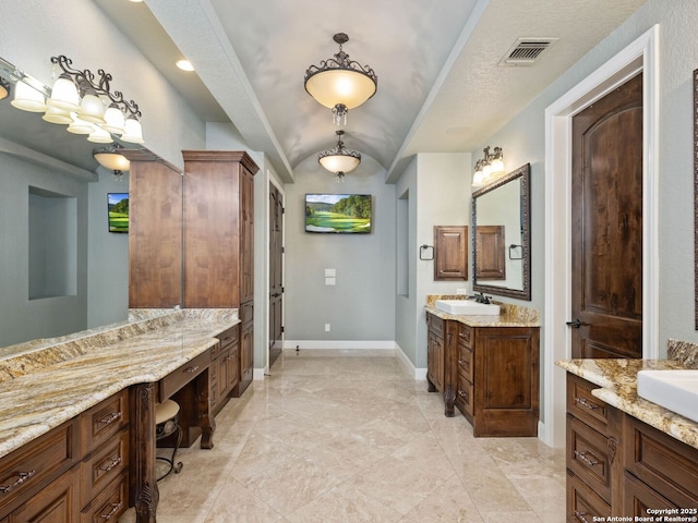 bathroom with vanity and a textured ceiling