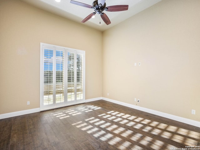 spare room with a wealth of natural light, dark hardwood / wood-style floors, and ceiling fan